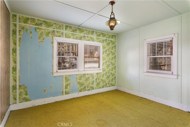 spare room with baseboards and wallpapered walls