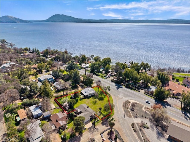 aerial view featuring a water and mountain view