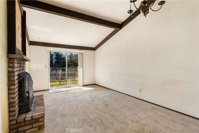 unfurnished living room featuring carpet floors, a notable chandelier, a fireplace, lofted ceiling with beams, and baseboards