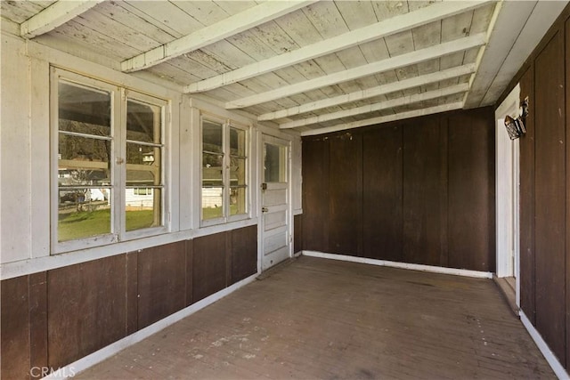 unfurnished sunroom with wood ceiling and beam ceiling