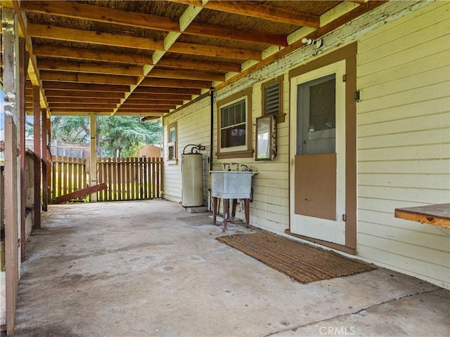 view of patio with a sink and gas water heater