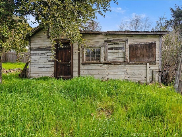 view of outbuilding featuring fence