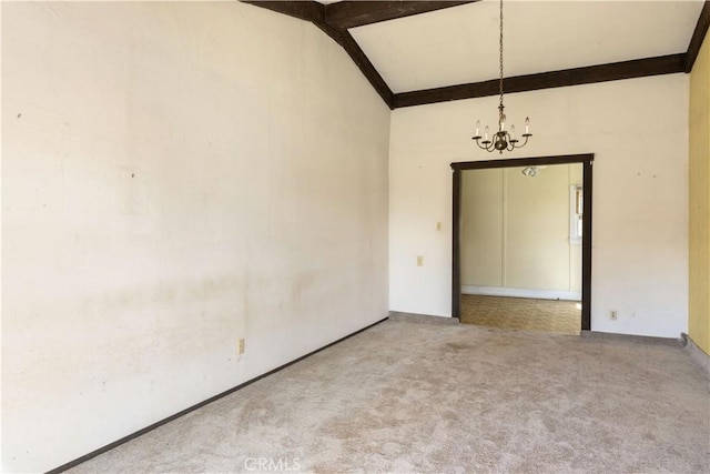 spare room with a chandelier, lofted ceiling with beams, and carpet flooring