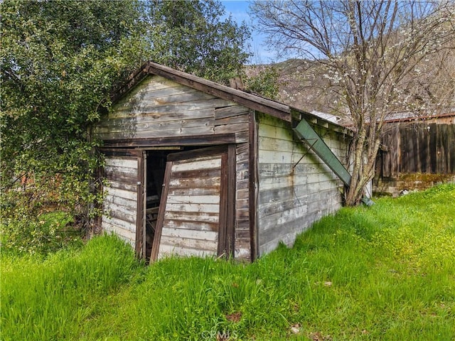 view of shed featuring fence