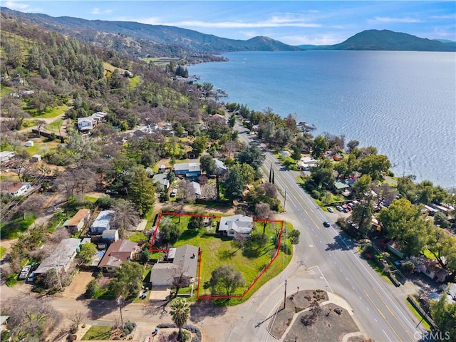 drone / aerial view with a water and mountain view