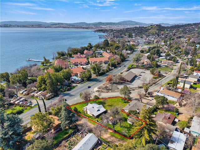 birds eye view of property featuring a water and mountain view