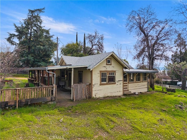 exterior space featuring a lawn and fence