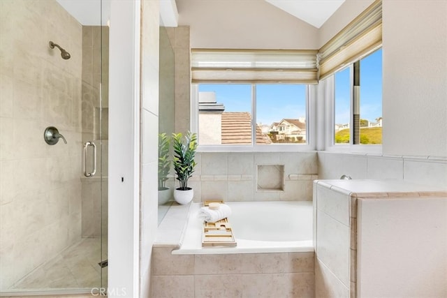 full bath featuring vaulted ceiling, a shower stall, and a bath