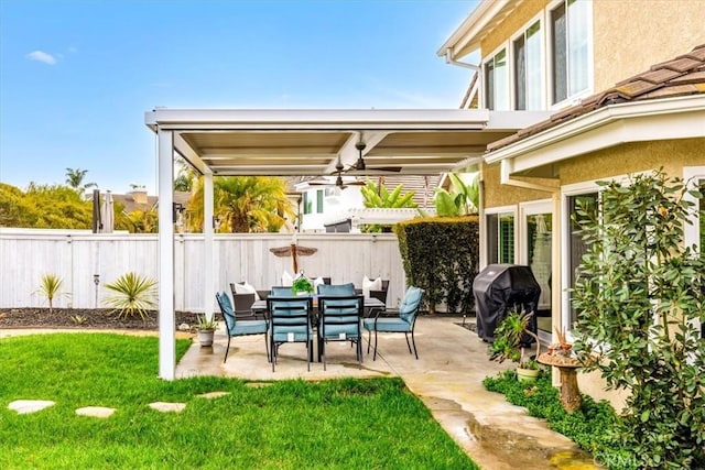 view of patio featuring a ceiling fan, a grill, and fence