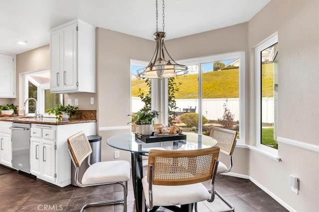 dining space featuring an inviting chandelier and baseboards