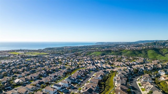 birds eye view of property with a water view and a residential view