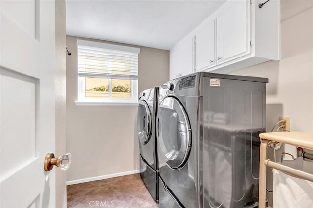 washroom featuring cabinet space, tile patterned flooring, baseboards, and separate washer and dryer