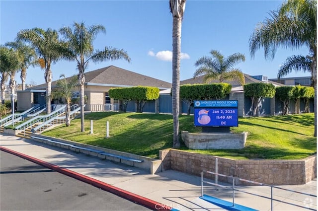 view of property's community with a lawn