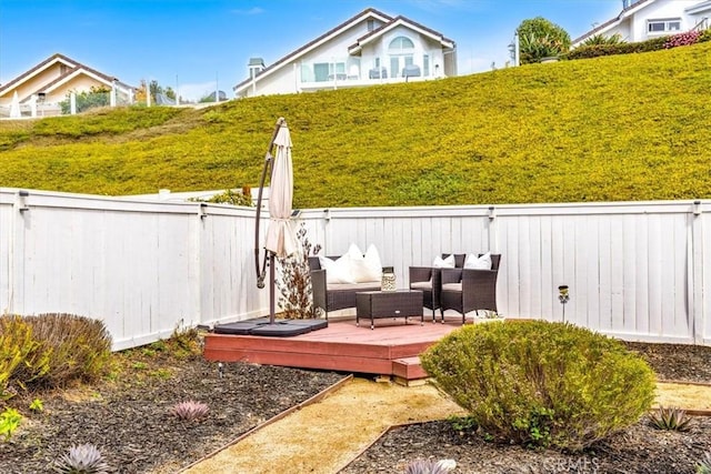 view of yard with outdoor lounge area, fence, and a wooden deck