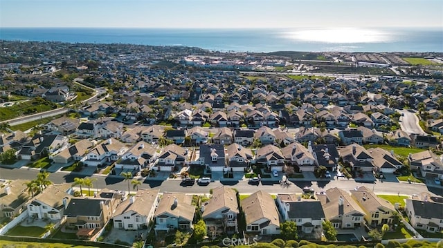 bird's eye view featuring a water view and a residential view