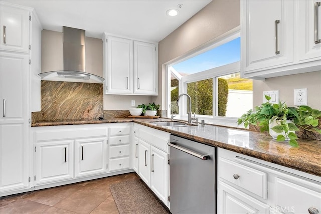 kitchen featuring black electric stovetop, stainless steel dishwasher, a sink, wall chimney range hood, and dark stone counters