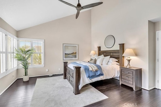 bedroom with high vaulted ceiling, dark wood-type flooring, and baseboards