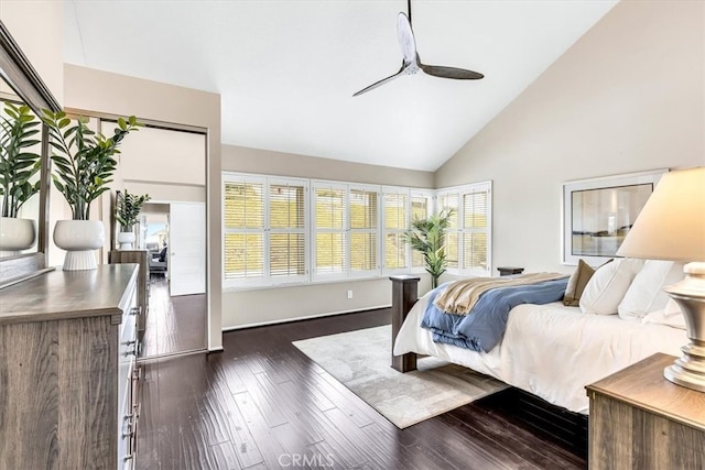 bedroom featuring dark wood-style floors, high vaulted ceiling, and ceiling fan