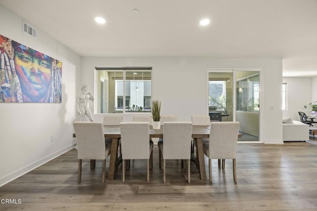 dining space with visible vents, wood finished floors, and recessed lighting