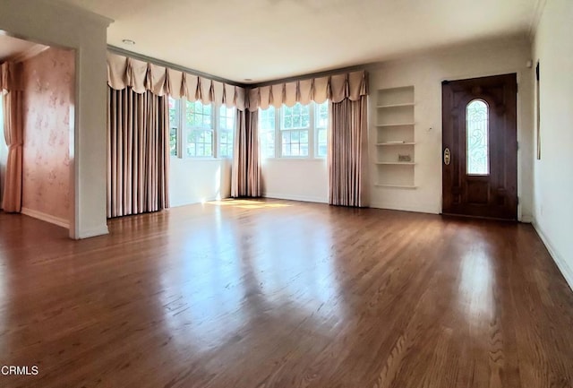 foyer entrance featuring wood finished floors and baseboards