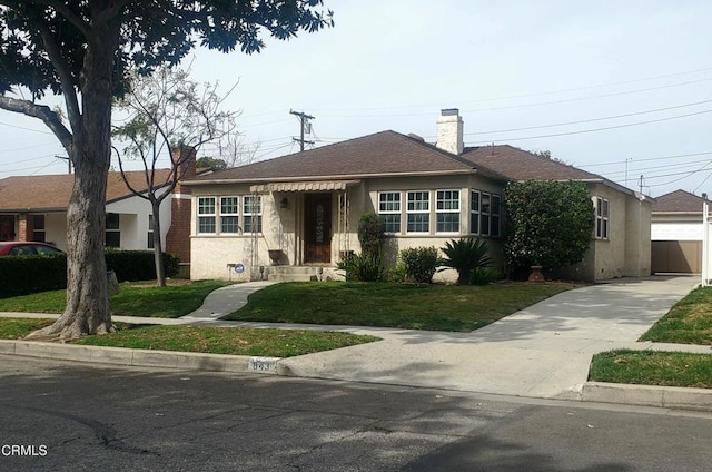 view of front of home featuring a garage, stucco siding, a chimney, roof with shingles, and a front yard