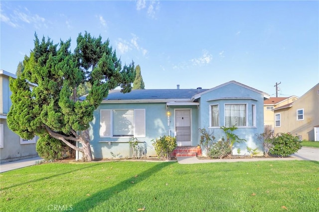 view of front facade featuring a front lawn and stucco siding