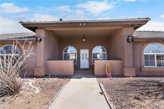 property entrance with stucco siding