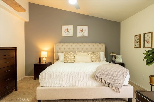 bedroom featuring light carpet, baseboards, and vaulted ceiling