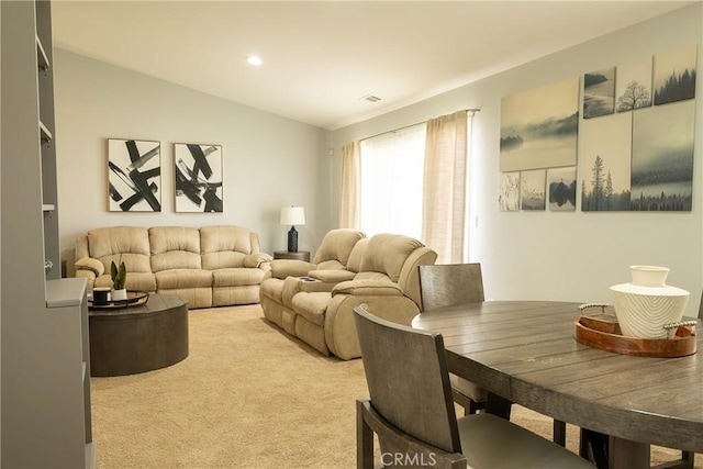 living area with recessed lighting, vaulted ceiling, and light colored carpet