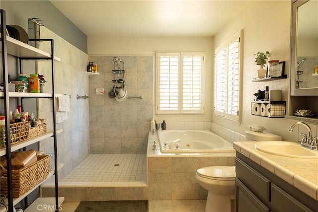 full bath featuring a walk in shower, toilet, vanity, a jetted tub, and tile patterned floors