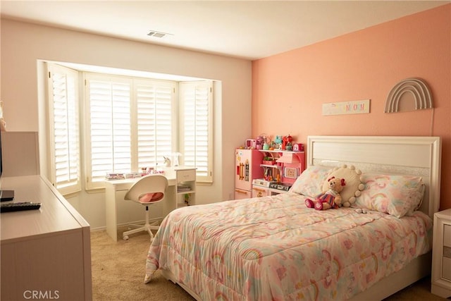 bedroom with baseboards, visible vents, and light colored carpet