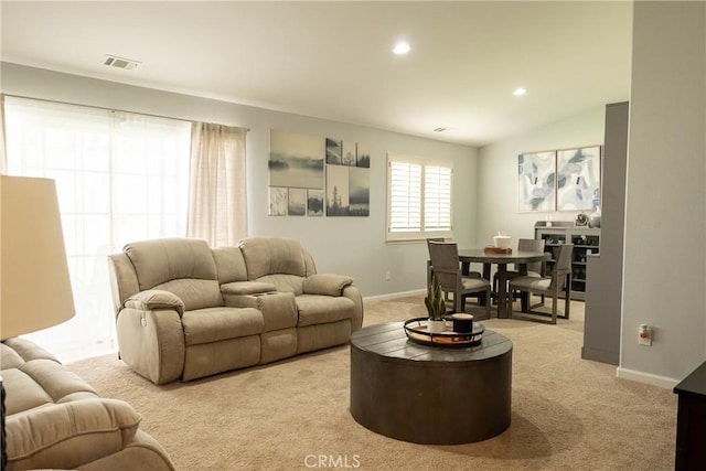 living room featuring recessed lighting, light colored carpet, visible vents, baseboards, and vaulted ceiling