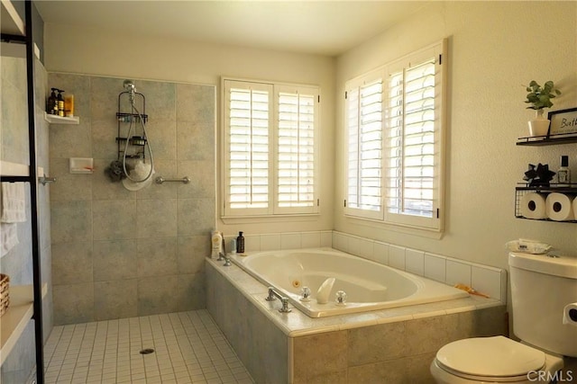 bathroom with tiled shower, a whirlpool tub, and toilet