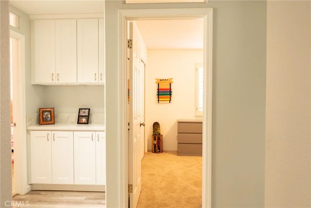 hallway with light colored carpet