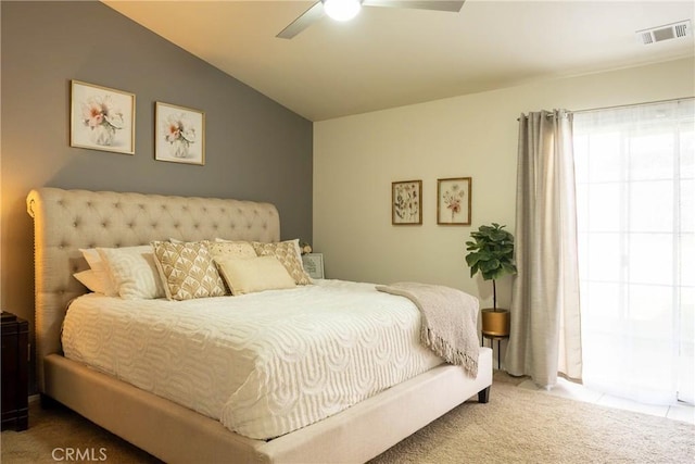 carpeted bedroom with lofted ceiling, ceiling fan, and visible vents