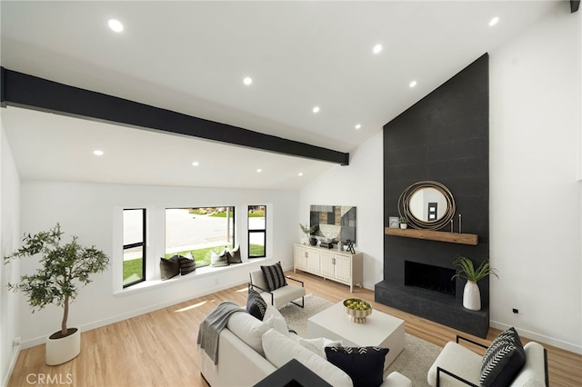 living area with a large fireplace, baseboards, light wood-type flooring, beam ceiling, and recessed lighting