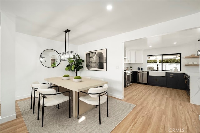 dining space with recessed lighting, baseboards, and light wood finished floors