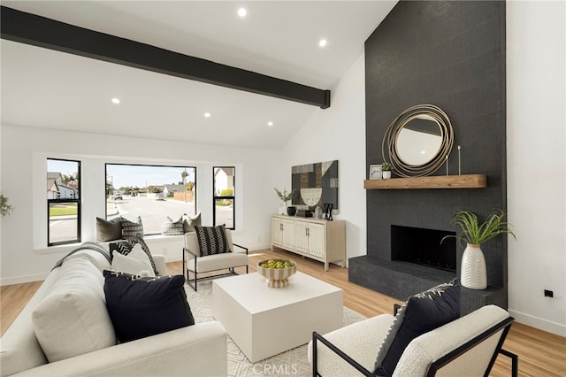 living area featuring recessed lighting, a large fireplace, baseboards, light wood-type flooring, and beam ceiling