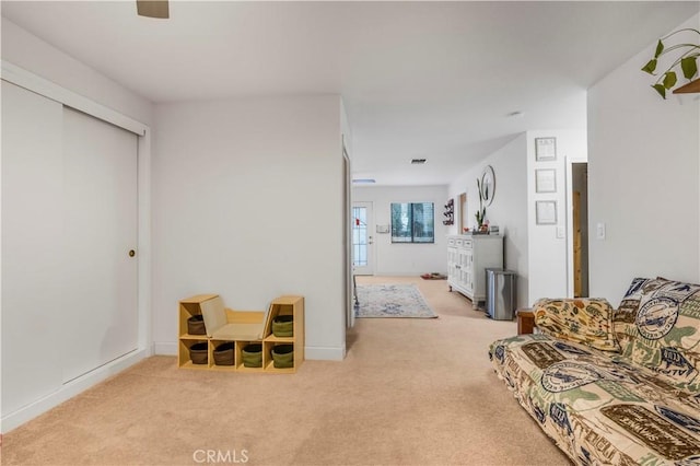 living room featuring visible vents and light colored carpet