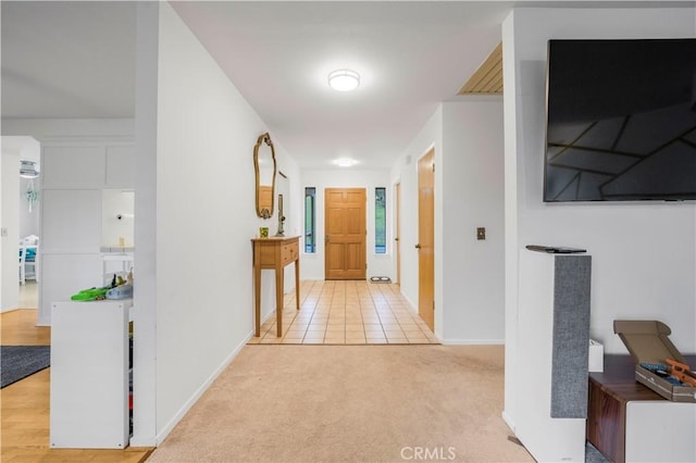 corridor with light carpet and baseboards