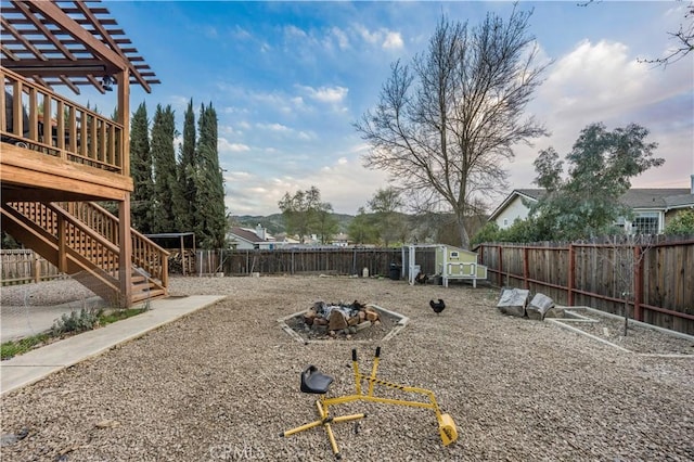 view of yard with a fenced backyard, stairs, and an outdoor structure