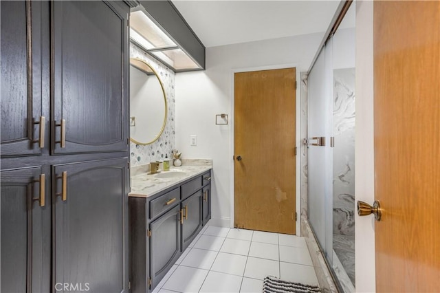 bathroom with a stall shower, vanity, and tile patterned floors