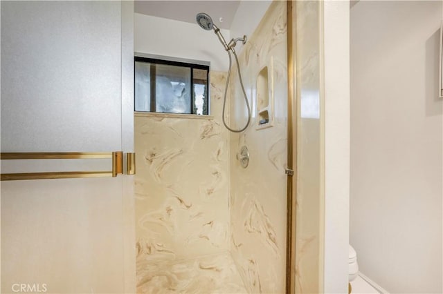 full bathroom with a marble finish shower and toilet