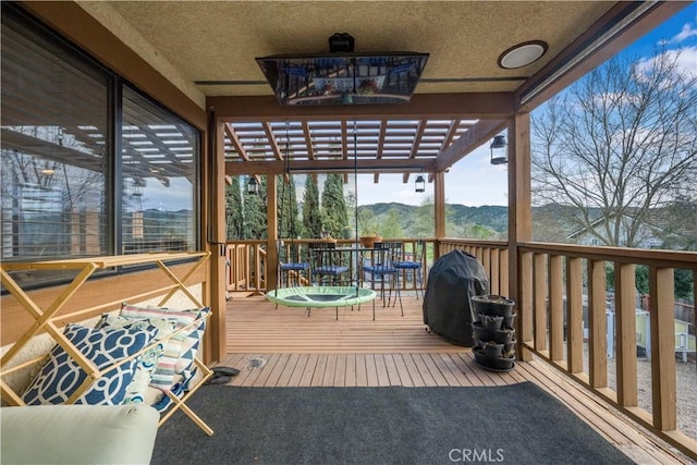 wooden terrace featuring a mountain view and area for grilling