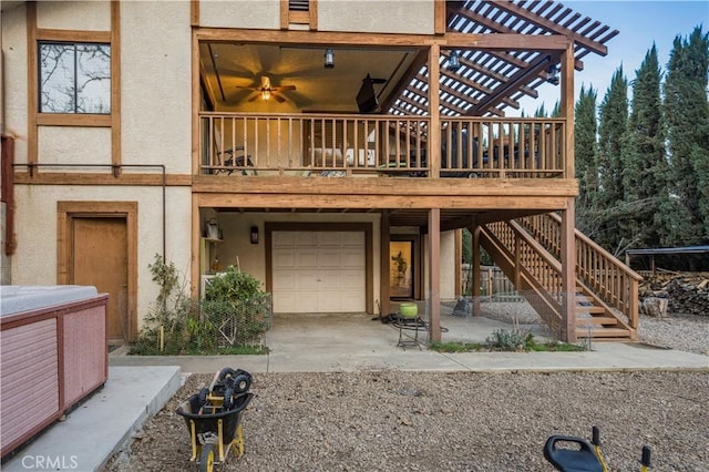 exterior space featuring an attached garage, driveway, stairway, and stucco siding