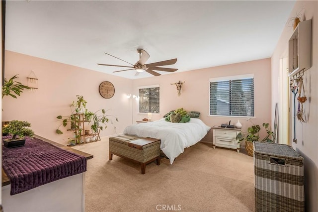 bedroom featuring light carpet and ceiling fan