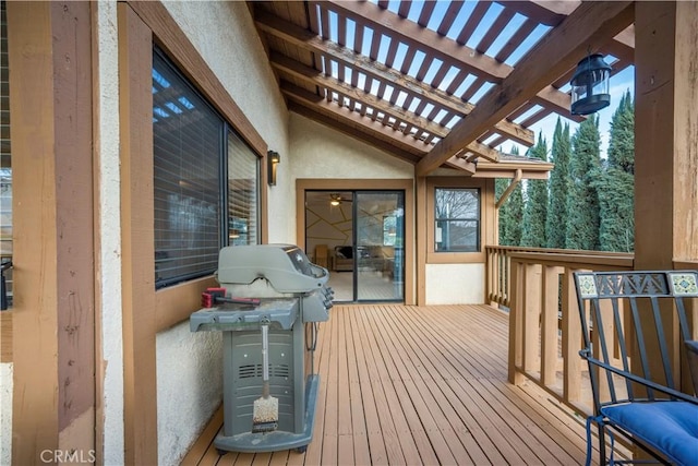 wooden deck featuring grilling area and a pergola