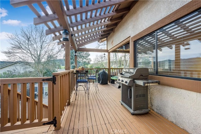 deck with area for grilling and a pergola