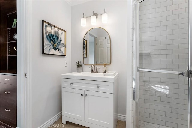 bathroom featuring baseboards, vanity, and a shower stall