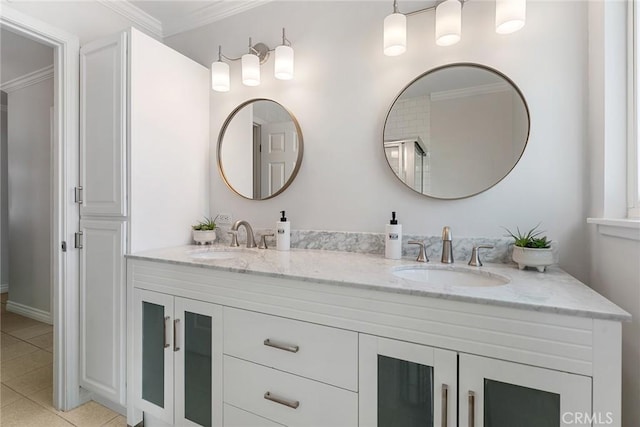 full bathroom with a sink, double vanity, ornamental molding, and tile patterned floors